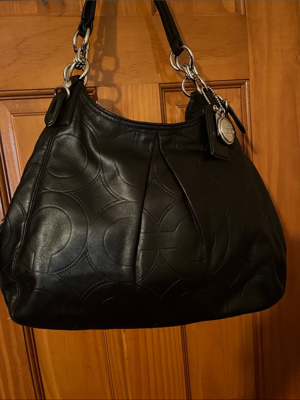 Coach Black Leather Shoulder Bag with Signature Embossed Circles.